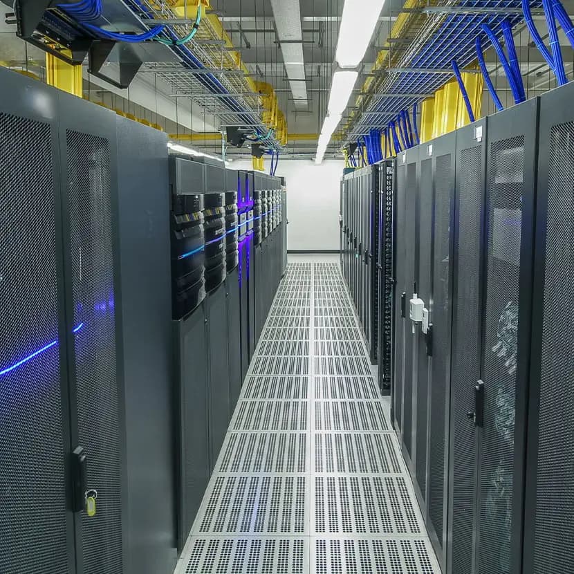 Data center aisle with server racks, overhead cable trays, and structured cabling for IT infrastructure cooling and airflow management