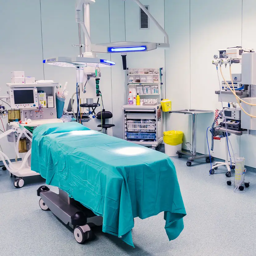 Hospital operating room with surgical table and advanced medical equipment for sterile procedures