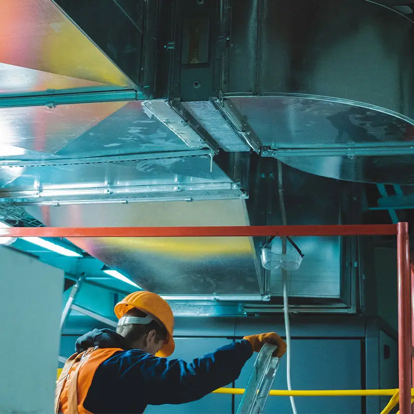 Technician calibrating HVAC system components for accurate airflow measurement