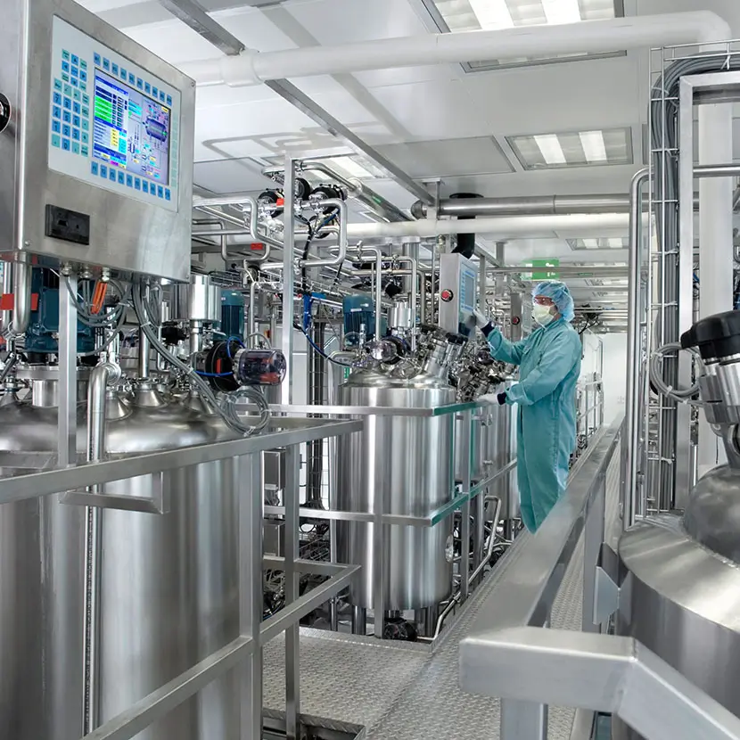 Biopharma cleanroom with stainless steel processing tanks and precision monitoring systems
