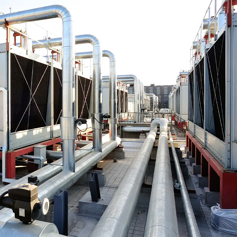 Industrial rooftop HVAC cooling system with large pipes and heat exchanger units for energy management